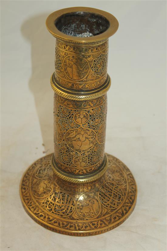 A 19th century Qajar Islamic pierced brass torch stand, 10.5in.